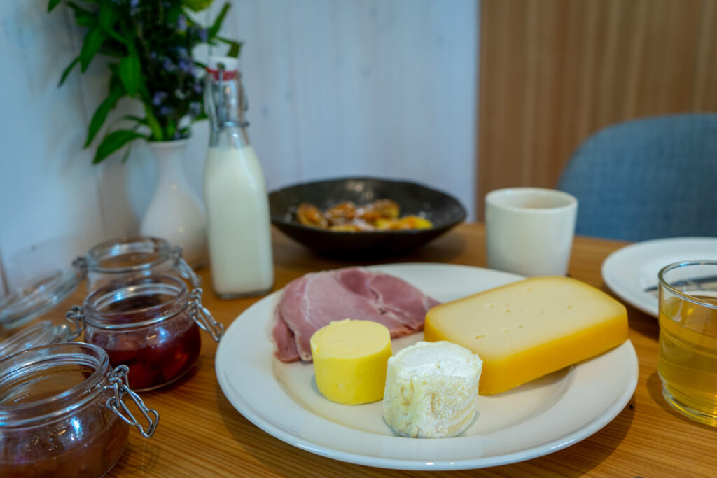 Een rijkelijke ontbijttafel met huisgemaakte confituren en een heerlijke geitenkaas.